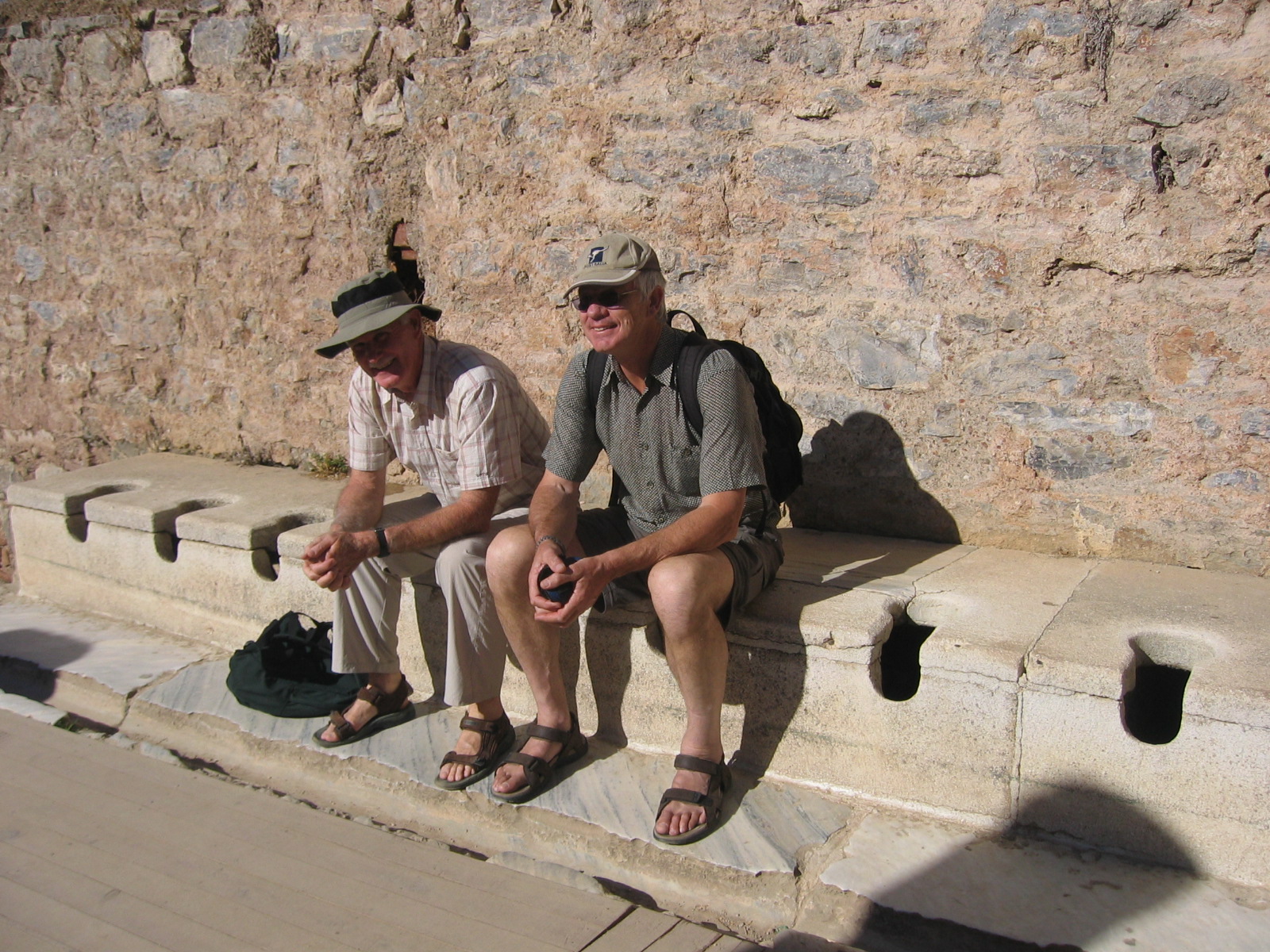 Richard & Barry using the open air commode-Can somebody spare a square?